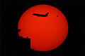Airplane from JFK airport passing in front of the Sun with sunspot AR2529 over Manhattan, New York 